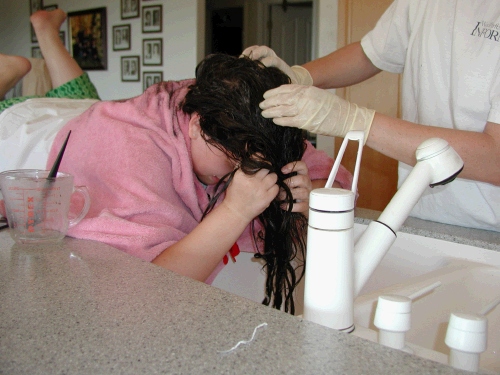 Her hair is so heavy (especially when wet) that finally we had her lie on the counter, so she wouldn't get so tired standing over the sink!