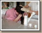 Her hair is so heavy (especially when wet) that finally we had her lie on the counter, so she wouldn't get so tired standing over the sink!