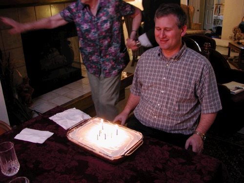 Bracing himself to blow out all 45 -- oh, I mean 9 candles . . . 4 blue - 5 green in the shape of an A.  What can I say?  We're cheap!