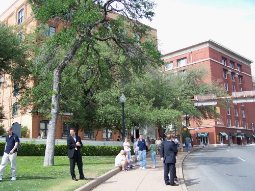 Looking back up the street -- not a good view of the book depository because of the tree -- but it gives you an idea of the building in conjunction with the street.