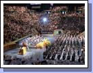 BYU graduation. Loren's fiance Anne Bogue is on the fourth row from the back down on the floor about 8 people in or so.  We were happy to finally find her!  If you look at the bottom of the photo you can see that a graduate has the number 3 on her hat -- that is my cousin Becky Breinholt.  She is sitting next to her sister Liz and their mother, my Aunt Susan who have the numbers 1 and 2 on their hats.  Three graduates in one family -- way to go!