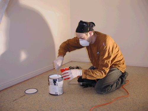 Jared thinning the paint in preparation for spraying the closet.