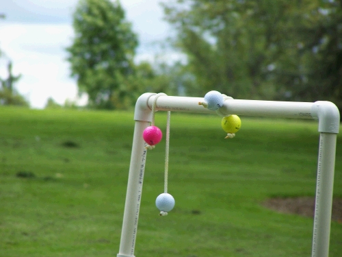 The idea is to throw a length of rope with golf balls attached to each end in the air toward the opposite pipe frame and try to get them to wrap around or at least rest across the bars.  Points are awarded and you can knock each others off.  Did any of that make sense?  We have one of these games -- if you are interested, you may borrow it -- it makes a great activity for the cub scouts...this I know.