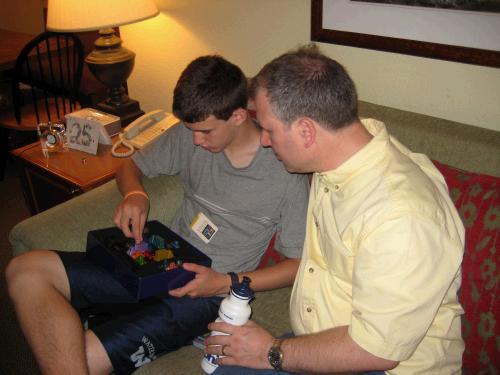 Alan looking on as Elliot works on a puzzle.