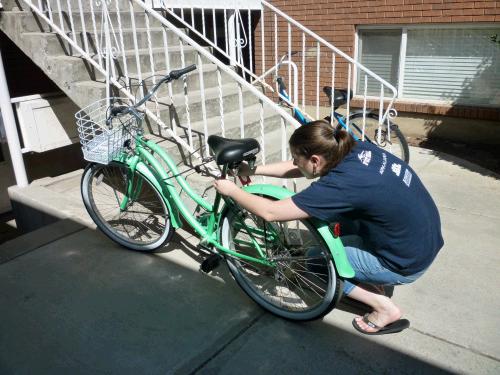 Madeleine putting her registration sticker on her new mode of transportation.  She has officially passed on to Elliot the somewhat dented, student driver, family Honda, and is now going to be pedaling a new darling beach cruiser around campus.   