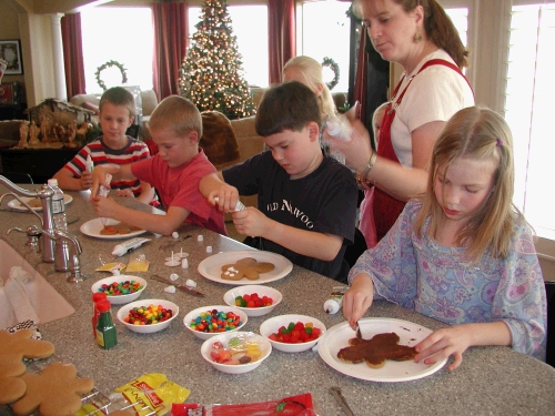 The cousins having fun decorating their gingerbread men.