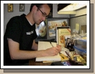 Writing in his journal at his desk.