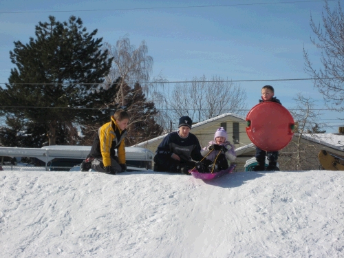 Elliot and Parker helping Karen and Andrew down the "kiddie" hill.