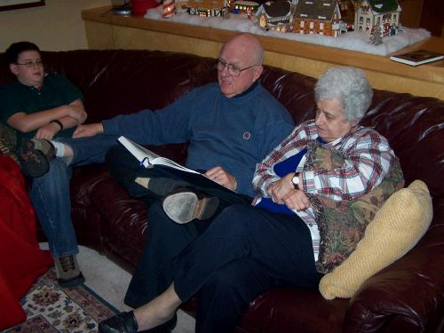 Grandpa reading the Christmas story from the Bible.