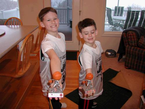 Elliot and Clark with their Jr. Jazz basketball trophies.