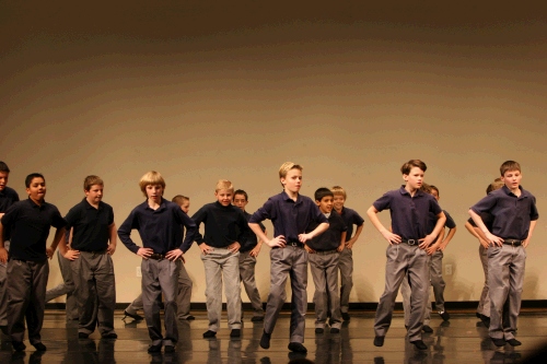 The fifth grade boys have the tradition of doing a Russian folk dance in the yearly dance recital.  They love it!  Everyone claps as the music starts to go faster and faster.
Elliot is on the front row - second from the right.  I think he's actually airborne!