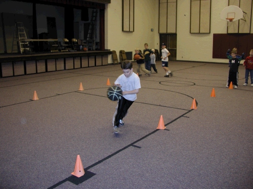 We took all the kids down the street to the church where we did various sports relays.  Here is Clark dribbling away...