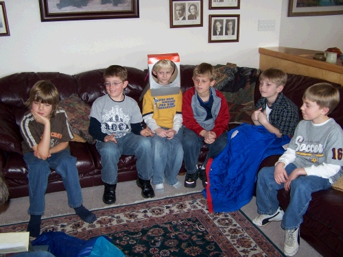 Clark's birthday party friends watching him open his presents.