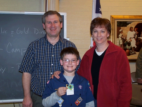 The proud Cub Scout with his parents and his new "Bear" badge.