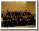 Madeleine with her school chamber orchestra.  She is just to the left of the guy in the middle of the front row.