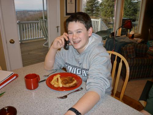 This is Clark's birthday dinner on his actual birthday.  Ever since he was a wee one, he has wanted grilled cheese and French fries -- works for me!  He is taking a "birthday call" from his sister Madeleine.