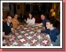 Gathered around the dining room table to tie a quilt for Haiti -- you just never know when those scout knots might come in handy!