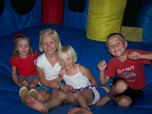 Karen Crapo, Marielle and Miranda Hulme and Justin Morgan -- Cousins having fun in the inflatable castle!