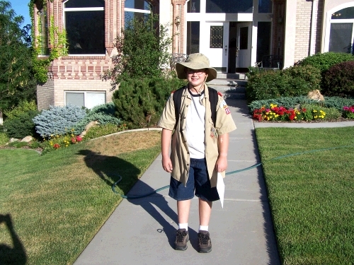 Clark is off to Cub Scout Camp with permission slip in hand and lunch on his back.