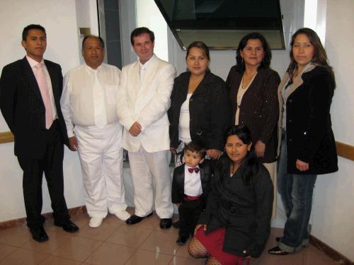 Baptism of Miguel Angel Fernandez Fernandez (right) baptized by his father-in-law (left.)  Next to him is his wife and their son is in the tux.