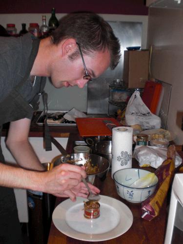 Loren plating the main dish starting with carmelized onion.