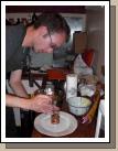 Loren plating the main dish starting with carmelized onion.