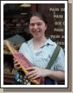 Anne happy to be buying bread at the market for dinner.