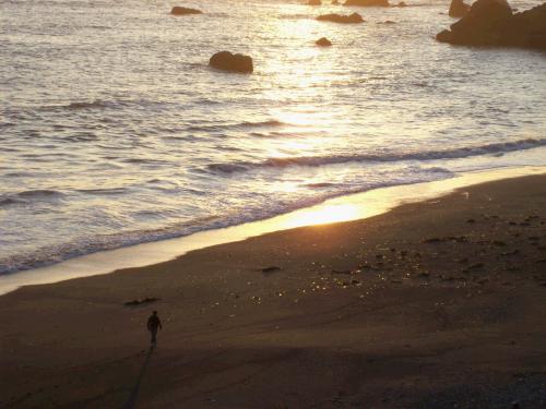 Madeleine captured this picture from our deck of me taking a sunset walk on the beach.