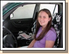 Tess ready to drive off on her own with her new driver's license and new Hawaiian seat covers!