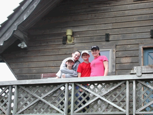 The kids standing on the deck of our beach house.