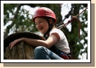 Madeleine climbing the eagle's perch at the ropes course. Once she reached the top, she had to stand on a really wobbly top and turn around. Then she had to jump off to catch a trapeze bar.