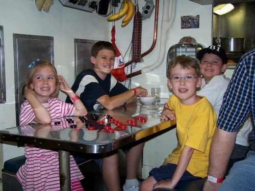 Here are the kids down below in the submarine's mess hall.  It was amazing to us that so many men could eat and sleep in such cramped quarters.