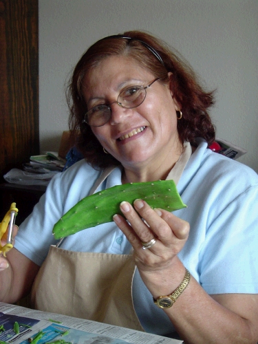 Sister Alaniz scrapes off the poky parts with a peeler.