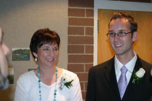 Mother and son visiting with guests.  Happy day.