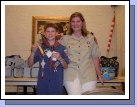 Elliot with his cub master, Stephanie Hogan.  He earned his Bear badge, gold and silver arrow and received his colors for Webelos.