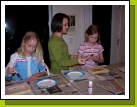 Tess helping Adelheid and Briana get started on their frames.