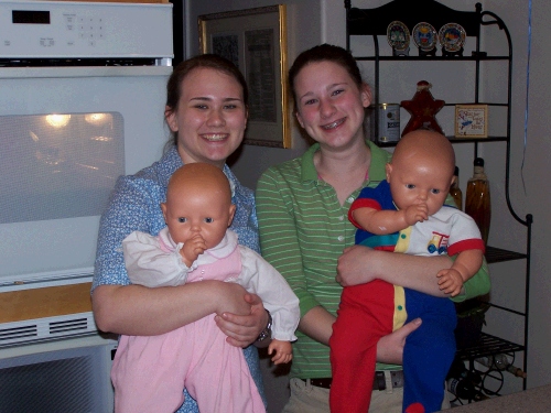 Tess and Madeleine goofing around with their old dolls Christene and Danny.  Maybe someday they will have real babies to goof around with?