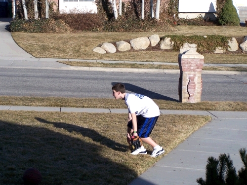 In the basketball and football shirt playing baseball...