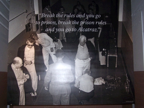 The photo isn't great, but it says, "Break the rules and you go to prison, break the prison rules and you go to Alcatraz."