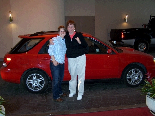 Me with our niece Jessica and her cute little red car.