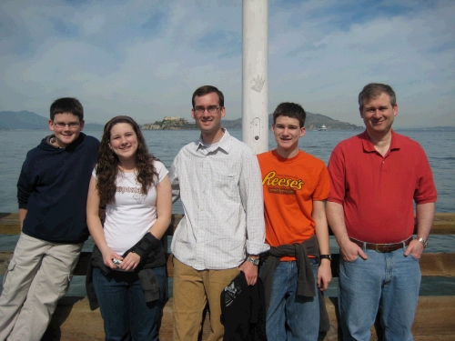 The gang on Fisherman's Wharf at the end of Pier 39 with Alcatraz in the distance between Madeleine and Loren.