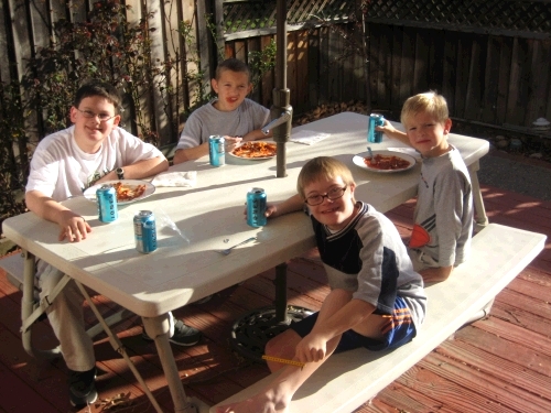 Boy cousins having dinner on the deck.  It was a beautiful day! LtoR: Clark, Joe, Ben, Coby