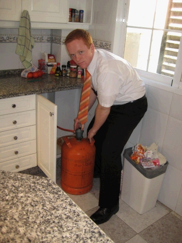 Elder Clark changing the "bombona" - how they get hot water.