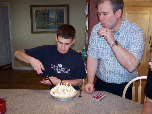 Elliot helping to light his own birthday candles.