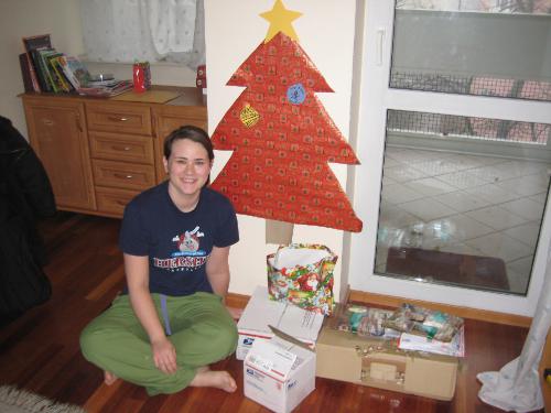 Christmas morning, ready to open her gifts under the Christmas tree