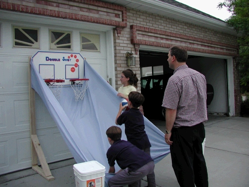 The first grade had an Invention Convention.  Clark decided we needed to figure out how to make a ball return for the backboard I picked up at DI for $12.