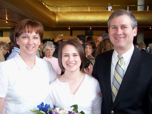 The graduate with the proud parents.