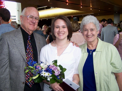 The graduate with the proud grandparents.