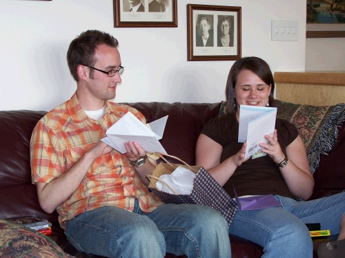 Phillip and Tess enjoying their cards from their grandparents -- ooh, is that a little green paper coming out of the bottom of Tess's card?