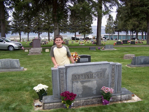 Here we are in the Ephraim Cemetery.  Clark is cleaning off presents left by the birds.  This is a monument to my great-grandfather Wilford Lewis Breinholt and his wife Jenny Marie Andreasen Breinholt.